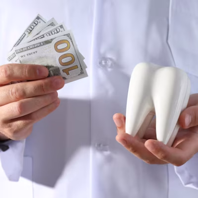 dollars-tooth-hands-dentist-gray-background_185193-156563